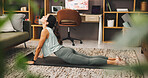 Woman, yoga and stretching with mat for pilates, workout or exercise on living room floor at home. Female person, yogi or warm up with cobra pose or strong core for fitness, zen or balance at house