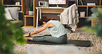 Woman, yoga and stretching with legs on mat for pilates, workout or exercise on living room floor at home. Female person, yogi or warm up with pose or practice for fitness, zen or balance at house