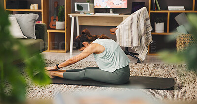 Buy stock photo Woman, yoga and stretching with legs on mat for pilates, holistic activity or exercise on living room floor at home. Person, yogi or warm up with pose or practice for fitness, zen or balance at house