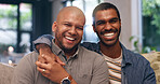 Home, gay couple and portrait with hug, smile and love for bonding in living room. Happy men, sofa and lgbt pride with marriage together in house lounge with queer romance and relationship care