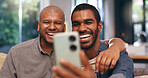 Gay, laughing or happy couple on video call in home together for bonding, relationship or love. Virtual chat, lgbtq or queer men with smile or funny joke on mobile app for social media, hug or selfie