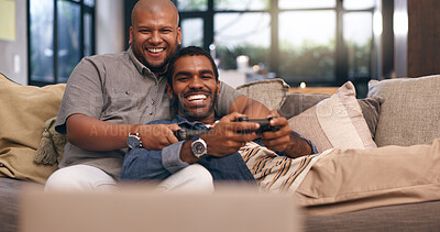 Buy stock photo Living room, gay couple and gaming with controller on sofa for multiplayer, competition and entertainment. Lgbtq, queer love and men with smile in home for esports challenge, streaming and contest