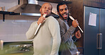 Gay couple, singing and men in kitchen, fun or bonding with music in house, karaoke or relationship. Home, romance and people with wooden spoon for song, lgbtq or happy for entertainment in apartment