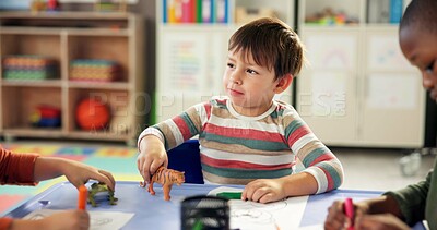 Buy stock photo Creative, toy and drawing with boy in classroom for child development, artwork and youth. Students, academy and growth with kids playing with plastic animal for knowledge, learning and education