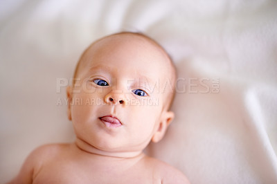Buy stock photo Baby, tongue out and portrait on sheet of bed with smile for playful, development and comfortable. Cute, blue eyes and face of infant on linen in nursery for future growth, childhood and rest at home