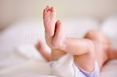 Buy stock photo Infant, legs and feet on sheet of bed with diaper for comfortable, delicate and growth in nursery. Body, relax and baby with tiny toes on linen for future development, childhood and peace at home