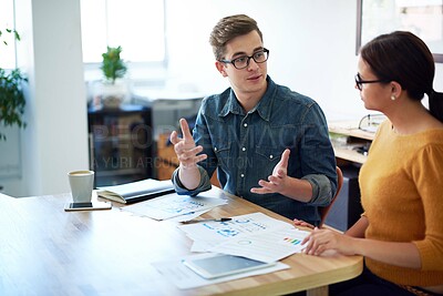 Buy stock photo Cropped shot of two coworkers having a discussion in the office