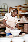 Sanding down the pot he's made