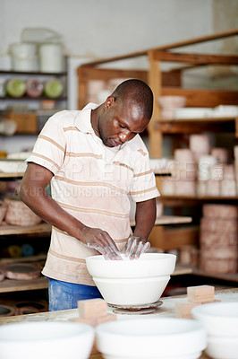 Buy stock photo Creative, design and pottery with black man in studio for manufacturing or production of ceramics. Artistic, process and shaping with craftsman in workshop for retail, small business or startup