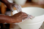 Sanding down his pot to create an even finish