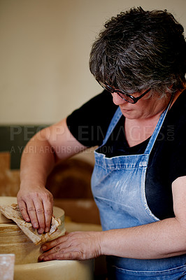 Buy stock photo Mature woman, clay and pottery at workshop, tools and ceramic manufacturing for craft, process and sculpture. Person, art and cloth for shape, design or results with creativity for texture at studio