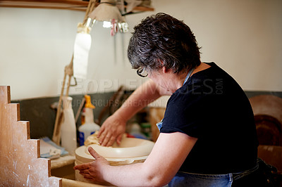 Buy stock photo Potter, woman or sponge sculpture in workshop for clay shaping, manufacturing process or custom design. Pottery small business, back or handmade bowl for order production, ceramic molding or cleaning