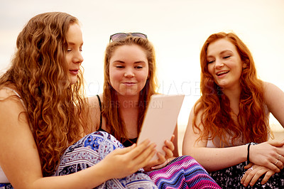 Buy stock photo Outdoor, women and friends with tablet, vacation and bonding together with break, relax and social media. Tropical island, group and happy people with tech, online reading and entertainment with app