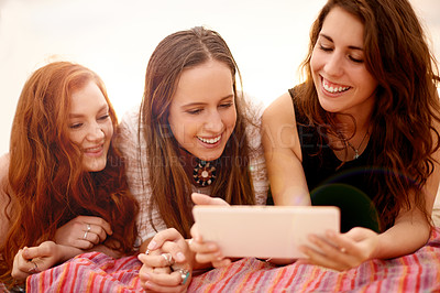 Buy stock photo Women, friends and outdoor with tablet for relax, social media and video memory on holiday. Happy people, tech and students at picnic for streaming service, connectivity or bonding on summer vacation