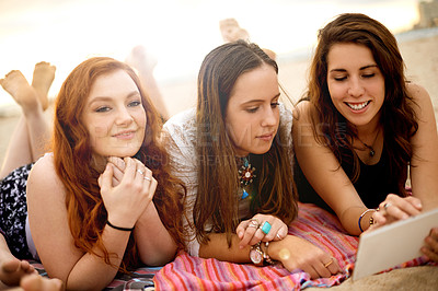 Buy stock photo Girl, friends and happy with tablet by beach for social media scroll, reading online news or streaming service. Holiday, people and relax with digital app on ocean coast for weekend break or vacation