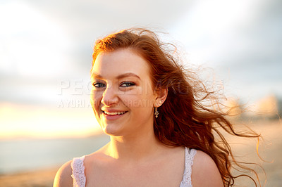 Buy stock photo Happy woman, portrait or beach with sunset for holiday, weekend or outdoor vacation in nature. Face, female person or red hair with smile, ocean coast or breeze for sunshine, fresh air or sandy shore