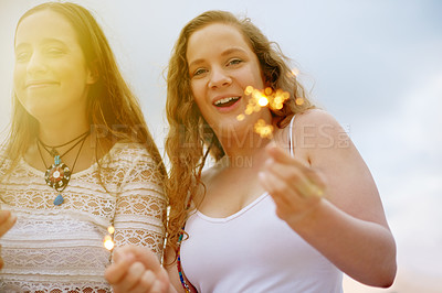 Buy stock photo Happy, sparklers and woman friends outdoor together in summer for bonding, holiday or vacation. Celebration, fireworks and smile of people at beach resort for tourism, travel or weekend getaway