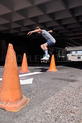 Buy stock photo City, jump and man with skateboard, stunt and skills for street skating, trick or performance for game. Outdoor, skateboarder and person with energy for competition, cone and action for extreme sport