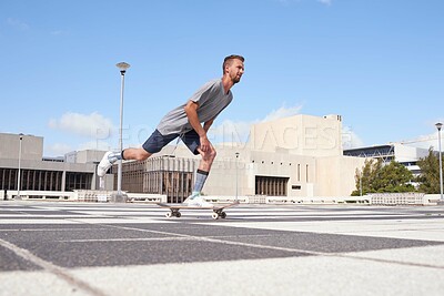 Buy stock photo Man, ride and city with skateboard for speed, motion or movement in an urban town or skate park. Male person, hipster or skater with wheelie board for sport, fitness or hobby during local commute