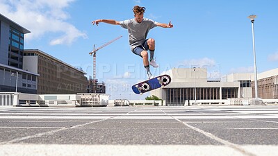 Buy stock photo Man, jump or flip stunt with skateboard in city for parkour challenge, extreme sport or cool skill. Male person, hipster or skating with board in air for control, balance or technique in urban town