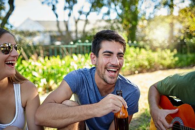 Buy stock photo Octoberfest, friends laughing and drink beer outdoor on summer holiday, vacation or relax. Funny people, group and alcohol in nature for party, celebration and guitar music at social gathering event