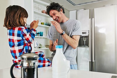 Buy stock photo Boy, clapping and father in kitchen of home, singing and song or nursery rhymes for bonding. Morning, entertainment and educational music with dad person and child, coffee and fun with single parent