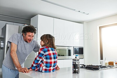 Buy stock photo Dad, boy and kitchen for breakfast in home, pancakes and coffee for sweet food in morning. Conversation, learning or father person with son for lesson on baking, nutrition or brunch for holiday snack