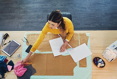 Buy stock photo High angle shot of an attractive young fashion designer in her workshop