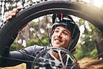 Bicycle, cycling and man check tire quality, pressure or stability for nature travel, exercise or fitness training. Mountain bike sports person checking wheel for health workout in Canada forest park