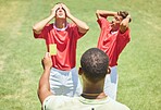 Sports, soccer and referee with yellow card standing on field with upset, angry and mad soccer players. Foul, mistake and athlete getting warning for rules violation in game or match on soccer field