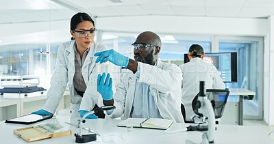 Buy stock photo Collaboration, experiment and people with chemical, lab and serious for breakthrough, liquid or notes. Healthcare, talking and colleagues with container for test, cure or medical research for vaccine
