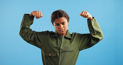 Buy stock photo Soldier, kid and girl with portrait, flexing arms and uniform with doubt on blue studio background. Face, mockup space and model with career day, serious and strong with power and fighter pilot