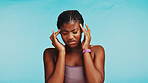 Fitness, black woman and pain of headache studio for exercise dehydration, muscle tension and intense workout. Mockup space, girl and migraine on blue background with brain fog, fatigue and dizzy 