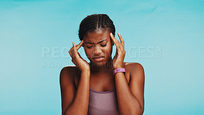 Buy stock photo Fitness, black woman and pain of headache studio for exercise dehydration, muscle tension and intense workout. Mockup space, girl and migraine on blue background with brain fog, fatigue and dizzy 