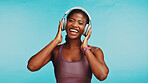 Headphones, portrait or black woman in studio, fitness or healthy model on blue background. African person, exercise goals or athlete with headset, listen to music or audio with celebration and sound