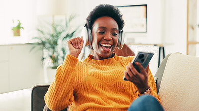 Buy stock photo Black woman, phone and headphones on sofa in home, music and relax with sound in living room. African person, smartphone and listening with audio, streaming and subscription on mobile app at house