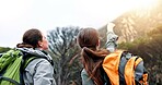 Women, hiking and point on mountain, direction and trees in forest, backpack or decision for route in nature. People, girl and friends with guide, location or trail with helping hand on path in Italy