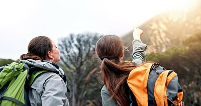 Buy stock photo Women, hiking and point on mountain, direction and trees in forest, backpack or decision for route in nature. People, girl and friends with guide, location or trail with helping hand on path in Italy