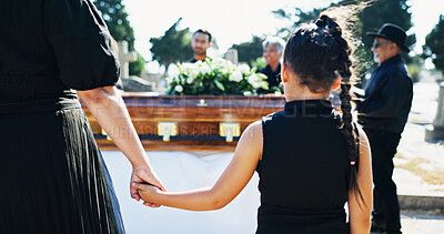 Buy stock photo Holding hands, funeral and family in graveyard, girl and parent with compassion, comfort and grief. Mother, kid and daughter with coffin, loss and burial for death, healing and support with mourning