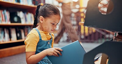Buy stock photo Girl, child and reading book in library, relax and smile with fantasy, education and novel. School, student and academic growth for development, storytelling and knowledge with vocabulary or learning
