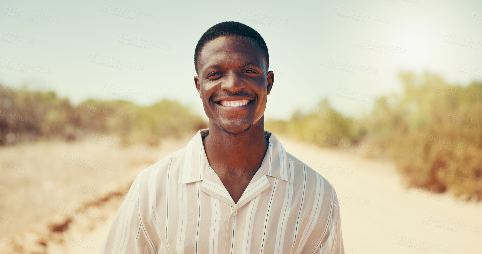 Buy stock photo Happy, travel and portrait of black man in countryside for adventure, holiday and vacation. Smile, relax and person in nature for destination, journey or explore safari for weekend in South Africa