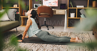 Buy stock photo Woman, yoga and stretching on mat for exercise or flexibility on living room floor at home. Female person, yogi or warm up with cobra pose or strong core for physical fitness, zen or balance at house