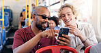 Smile, men and friends with phone on bus for browsing social media, reading blog and public transport. Happy, people and point with mobile for commute schedule, chat notification and morning journey