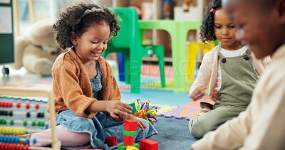 Buy stock photo Education, student and playing with building blocks in classroom for creative development, fun activity or learning. Happy, kids or stack toys at kindergarten for coordination and sensory imagination