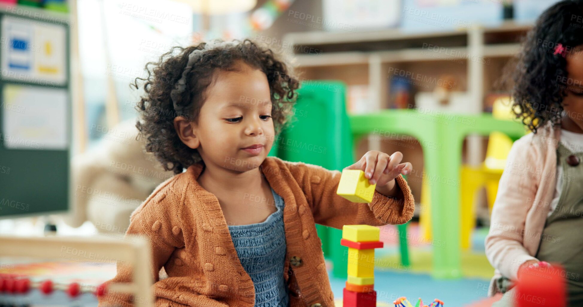 Buy stock photo Education, girl and playing with building blocks in classroom for creative activity, motor development and learning. Child student, kindergarten and stack toys for problem solving and coordination