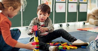 Buy stock photo Education, children or playing with building blocks in classroom for creative imagination, motor skills or learning. Solution, student or stack toys at kindergarten for problem solving or development