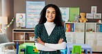 Woman, teacher and portrait in classroom with confidence, smile and montessori about us. Educator, kindergarten and arms crossed in school for education, career pride or passion for child development