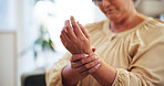 Carpal tunnel, injury and woman with wrist pain in home for joint inflammation, muscle sprain or ache. Medical emergency, closeup and female person with arthritis or osteoporosis in hand at house.
