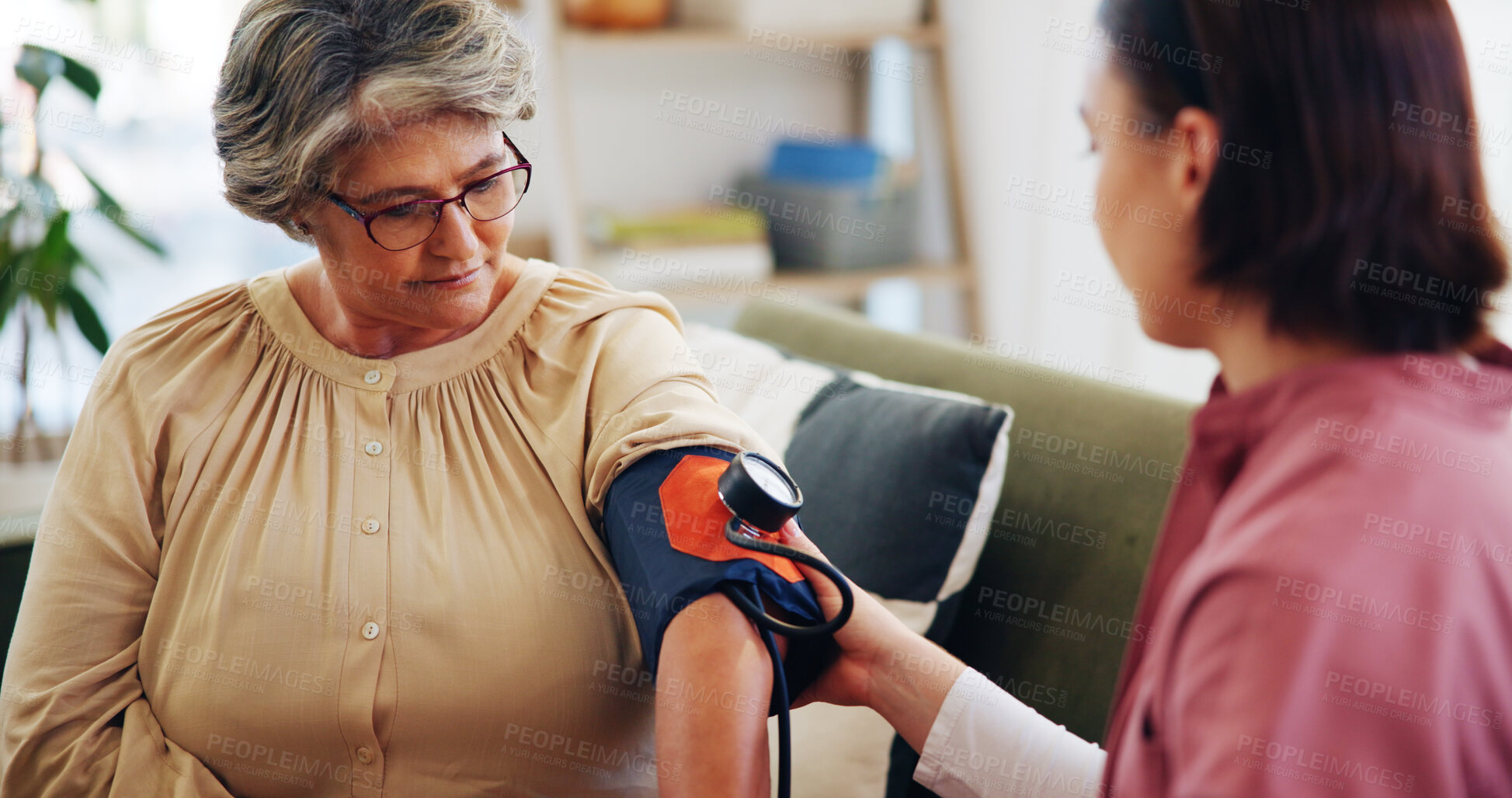 Buy stock photo Caregiver, senior woman and blood pressure in home for wellness check, diabetes assessment and health support. Nurse, test and BPM machine on sofa for medical service, hypertension level or diagnosis
