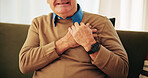 Heart attack, chest pain and hands of senior man on sofa with worry for emergency, medical crisis and accident. Retirement, home and mature person with discomfort, breathing strain and stroke